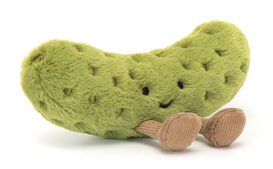 Kuscheltier, eine Süße Saure Gurke von Jellycat mit Füßen und freundlichem Gesicht, Ansicht von schräg vorne.