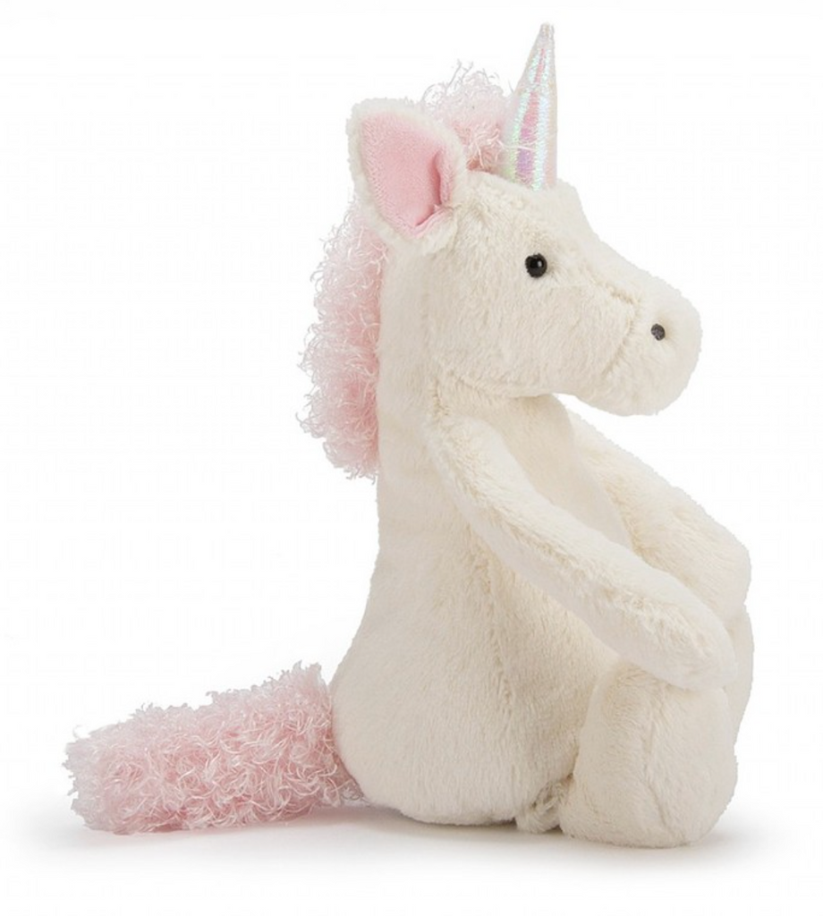 Verschmustes Bashful Unicorn Kuscheltier von Jellycat. Plüschiges Einhorn mit weißem Fell und rosaner Mähne und Schweif. Seitliche Ansicht 