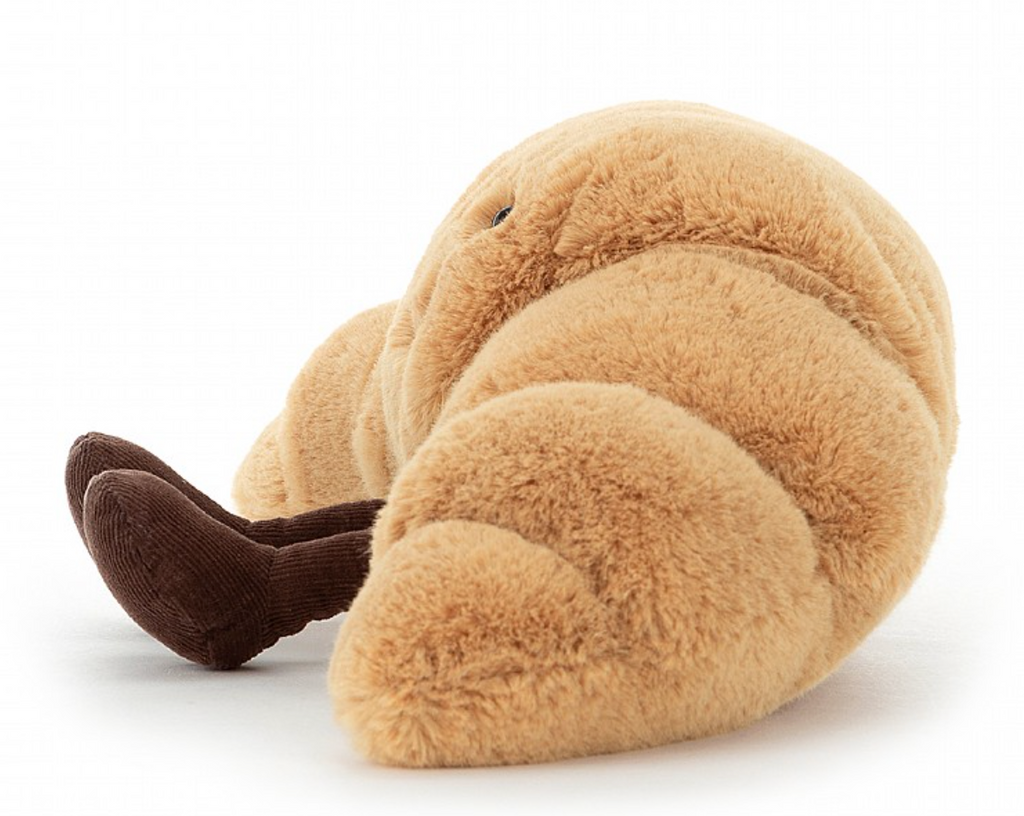 Kuscheliges Gebäck Croissant Kuscheltier mit Beinen und Gesicht von Jellycat , seitliche Ansicht